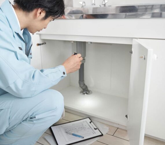 a-japanese-male-worker-checks-the-plumbing-2025-03-13-17-59-15-utc
